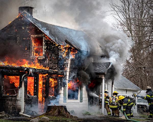 Firefighters extinguishing house fire